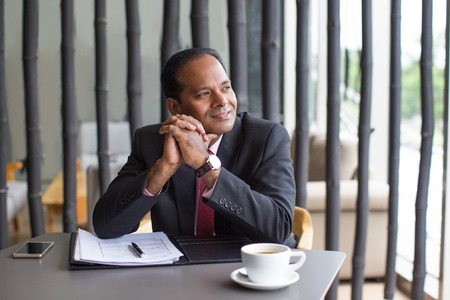 Dreamy Business Man Working With Document in Cafe