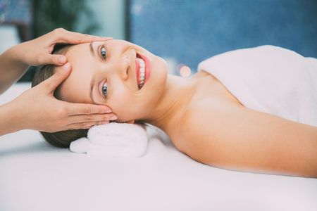 Happy Young Woman Getting Head Massage in Spaの写真素材