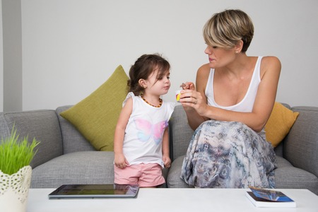 Mother taking care of her daughterの写真素材