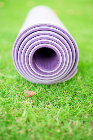 Close-up of purple yoga mat on grassの写真素材