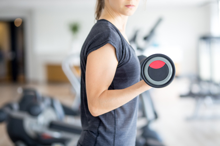 Cropped View of Woman Training With Dumbbellの写真素材