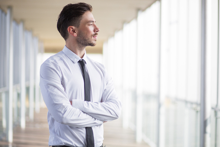 Ambitious and confident businessman in corridorの写真素材