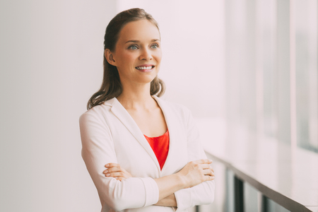 Pretty Smiling Business Woman Standing at Windowの写真素材
