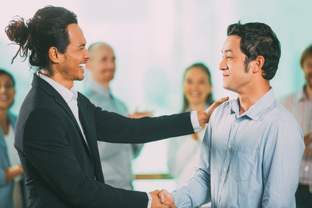 Joyful Businessmen Shaking Hands after Meetingの写真素材