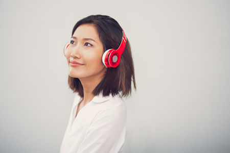 Closeup of Content Young Woman Wearing Headphonesの写真素材