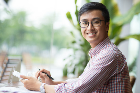 Portrait of smiling young manager with touchpadの写真素材