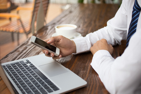 Businessman using technology in cafe