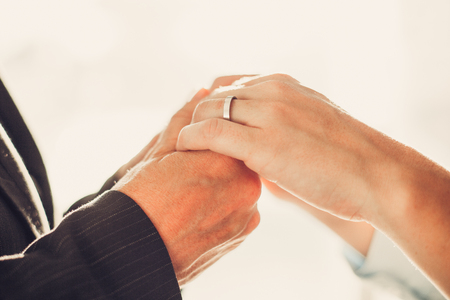 Close-up of man holding wifes handsの写真素材