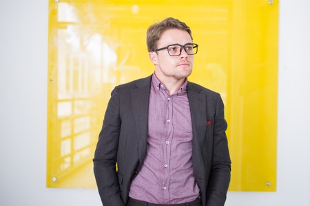 Confident manager standing at information boardの写真素材