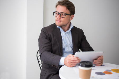 Pensive young man thinking of business strategyの写真素材