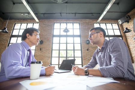 Business Partners Negotiating in Loft Officeの写真素材