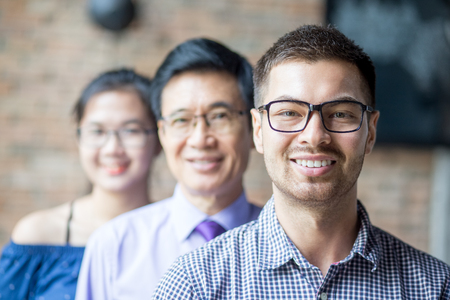 Smiling Diverse Business Team Standing in Rowの写真素材