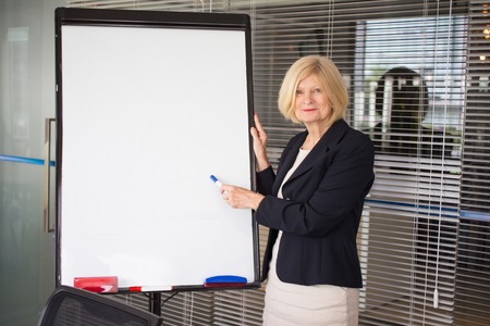 Smiling Senior Business Woman Conducting Seminarの写真素材