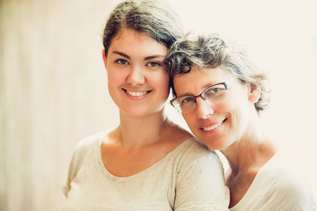 Portrait of happy senior mother and teen daughterの写真素材
