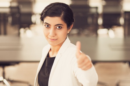 Successful Asian businesswoman showing thumb upの写真素材