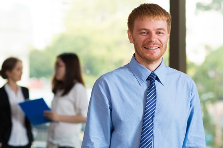 Portrait of smiling young businessman and his team
