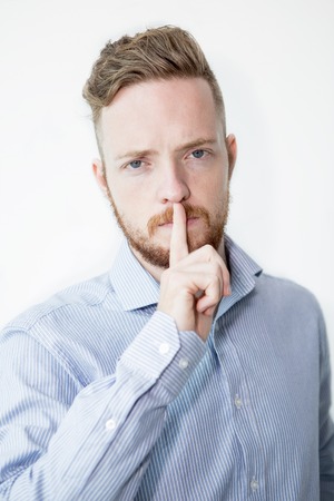 Serious Young Man Making Silence Gestureの写真素材