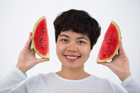 Smiling Asian Girl Holding Slices of Watermelonの写真素材