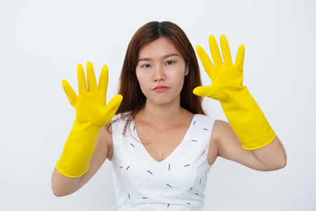 Sad Vietnamese housewife in rubber glovesの写真素材