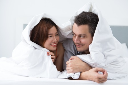Loving young newlyweds resting in hotel roomの写真素材