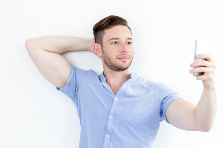 Handsome muscled young man posing for selfieの写真素材