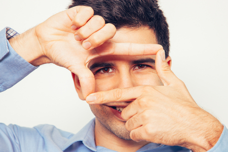 Smiling Young Handsome Man Making Frame Gestureの写真素材
