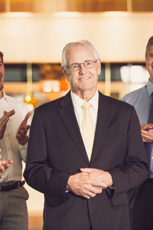 Colleagues Applauding to Senior Business Leaderの写真素材