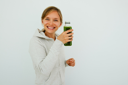 Satisfied healthy woman drinking smoothieの写真素材
