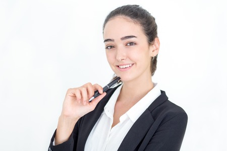 Portrait of happy young businesswoman holding penの写真素材