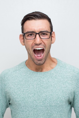 Closeup of Angry Young Man Shouting Loudの写真素材