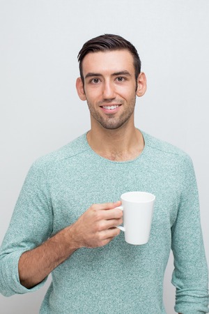 Closeup of Smiling Handsome Man Having Tea