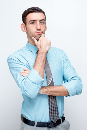 Confident Thoughtful Business Man Touching Chinの写真素材