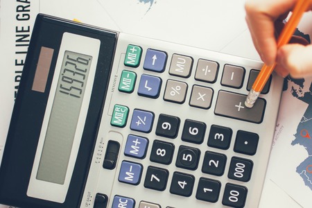 Cropped View of Hand Computing on Calculatorの写真素材