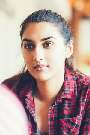 Concentrated Indian woman talking to friendの写真素材