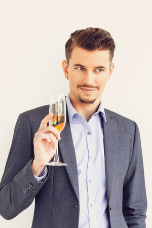 Portrait of successful businessman with champagneの写真素材