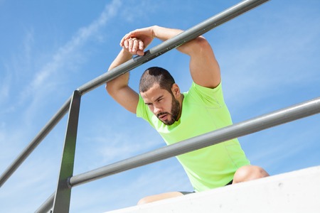 Tired Muscular Sporty Man Leaning on Railing