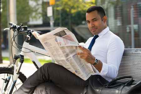 Handsome Hispanic Businessman with Paper in Parkの写真素材