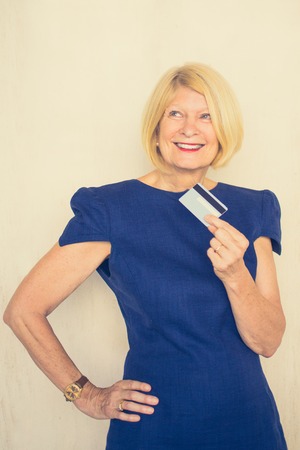 Smiling Attractive Senior Lady Holding Credit Card