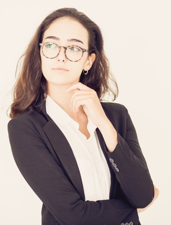 Confident businesswoman in eyeglasses looking awayの写真素材