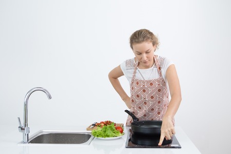 Unhappy woman rubbing grease stains with fingerの写真素材