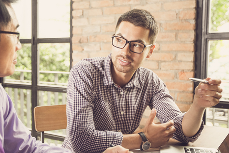 Two Serious Colleagues Talking in Loft Officeの写真素材