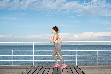 Beautiful Sporty Woman Jogging on Bridgeの写真素材