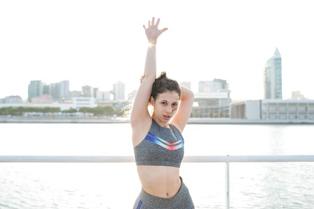 Sexy Pretty Sporty Girl Posing by City River