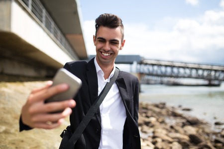 Happy businessman walking on shoreの写真素材