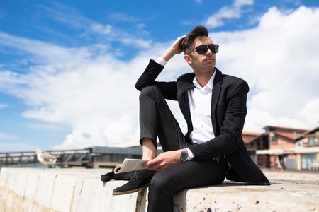 Pensive handsome businessman dreaming of futureの写真素材