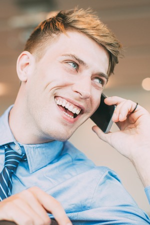 Laughing Business Man Talking on Mobile Phoneの写真素材