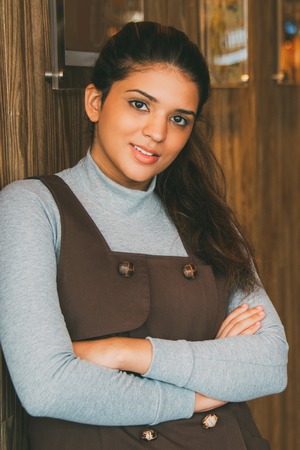 Portrait of successful female cafe owner smiling