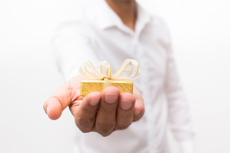 Cropped View of Man Holding Small Gift Box on Palmの写真素材