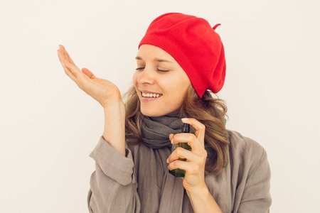 Enjoyable French woman smelling perfume