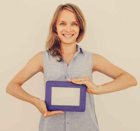 Happy Pretty Woman Holding Blank Picture Frame
